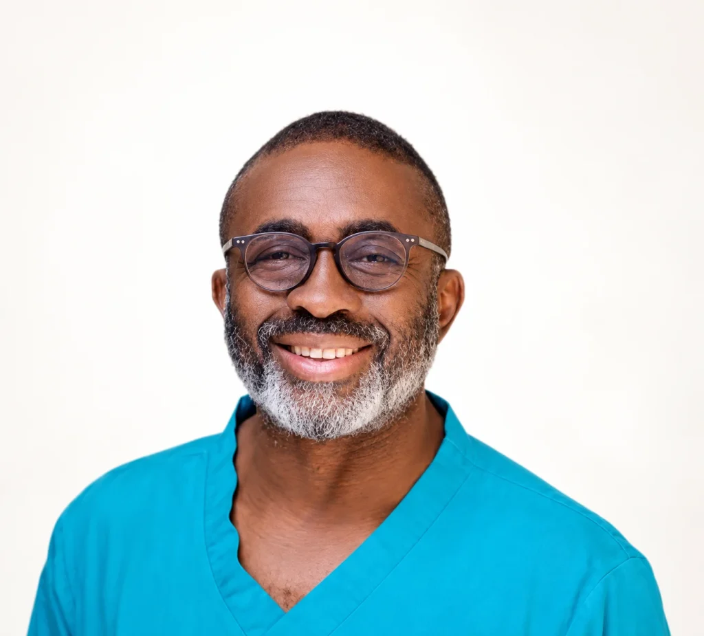 Dr Ikechukwu Augustine Nwachukwu smiling in blue clinical scrubs