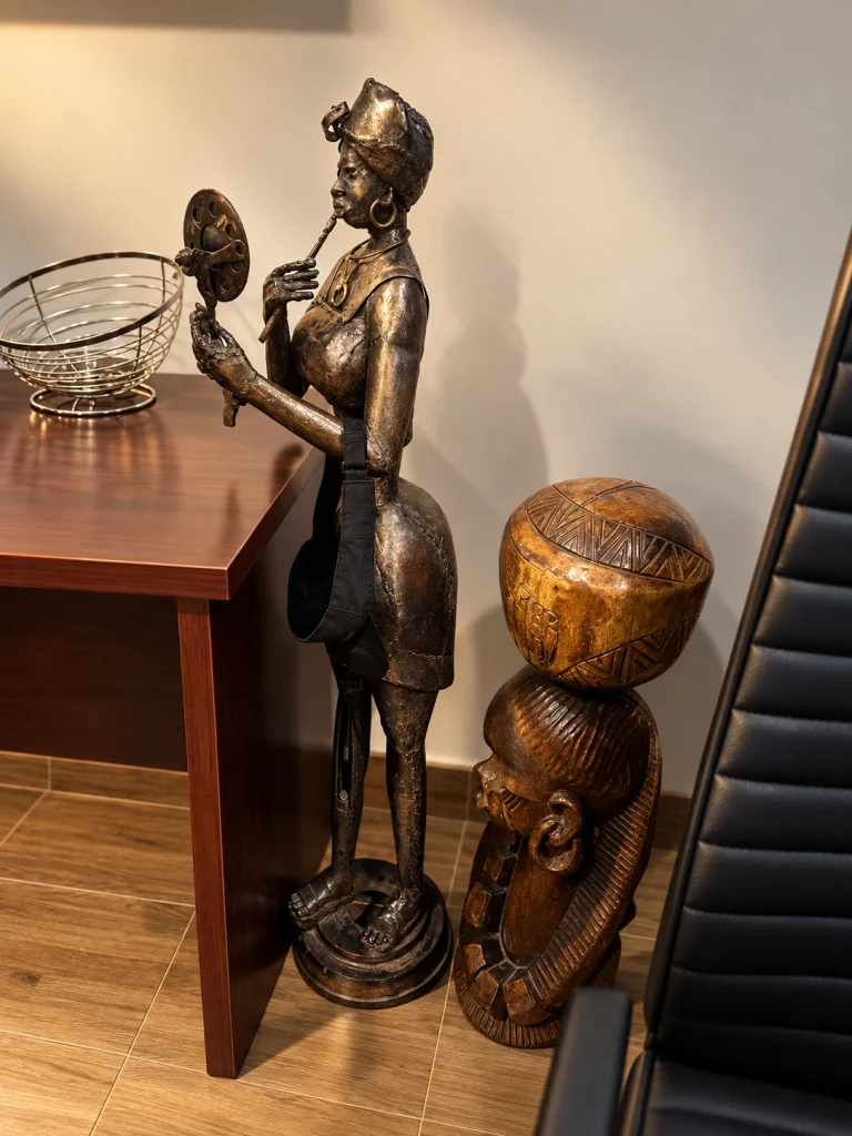 Figurative sculpture and carved wooden head near reception